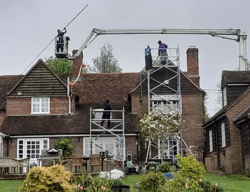 The Moss Cleaners using cherry picker and scaffolding to clean roof safely and professionally in Purton, Wiltshire